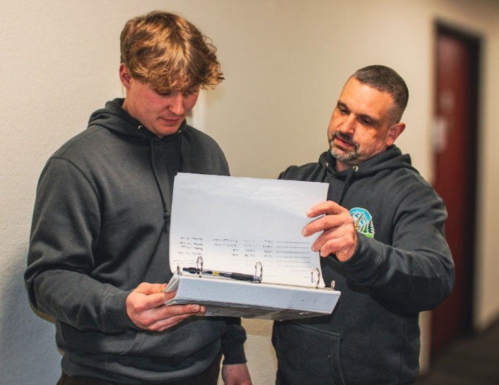 Licensed electrician reviewing electrical plans with a team member at Johnson Electrical Services