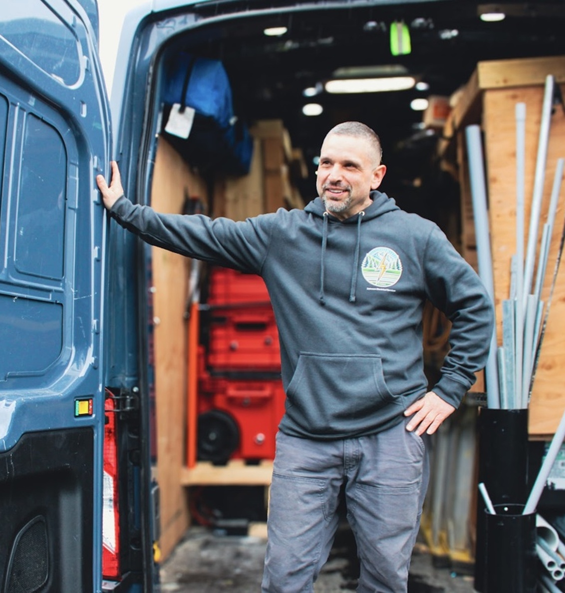 johnson-electrical-services-bellingham-wa-electrician-service-van Johnson Electrical Services electrician standing beside a service van in Bellingham, WA.